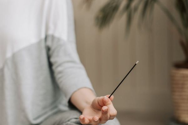 Person meditating peacefully in a calm, focused environment.