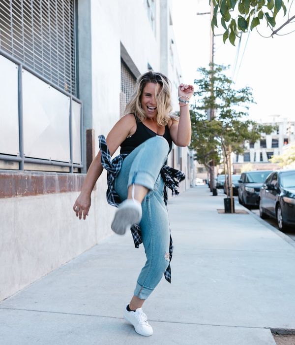 Woman feeling vibrant and energetic in a bright, modern space.